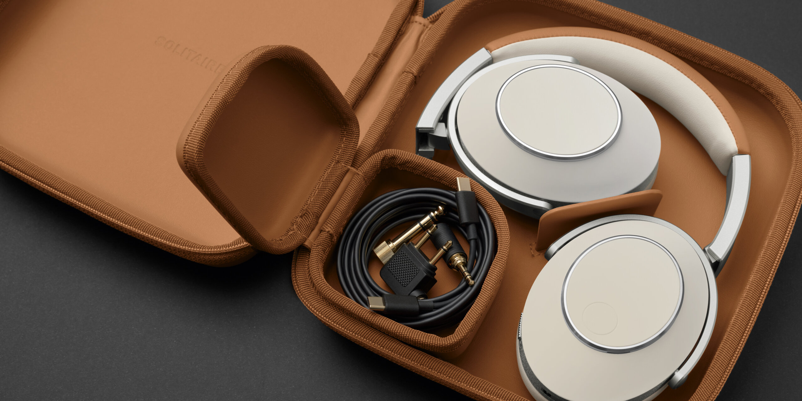 The T+A Solitaire T finished in Cognac White, shown in transport case.